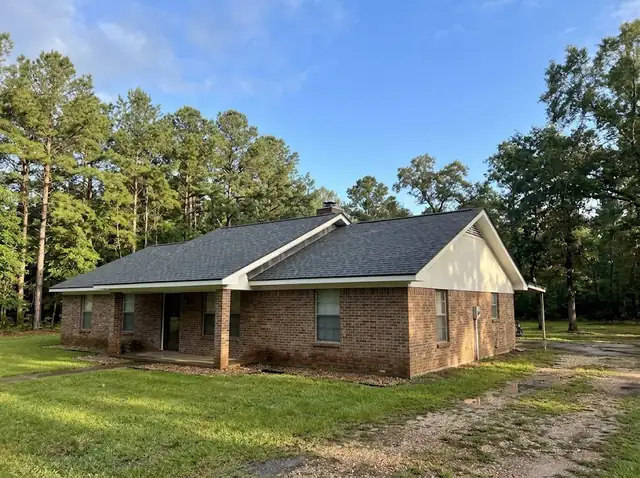 Illustration of a repaired shingle roof on a brick ranch home among pine trees